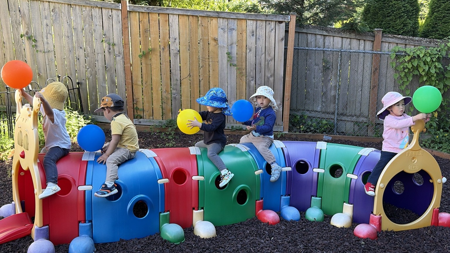 Children playing together on colorful outdoor climbing equipment