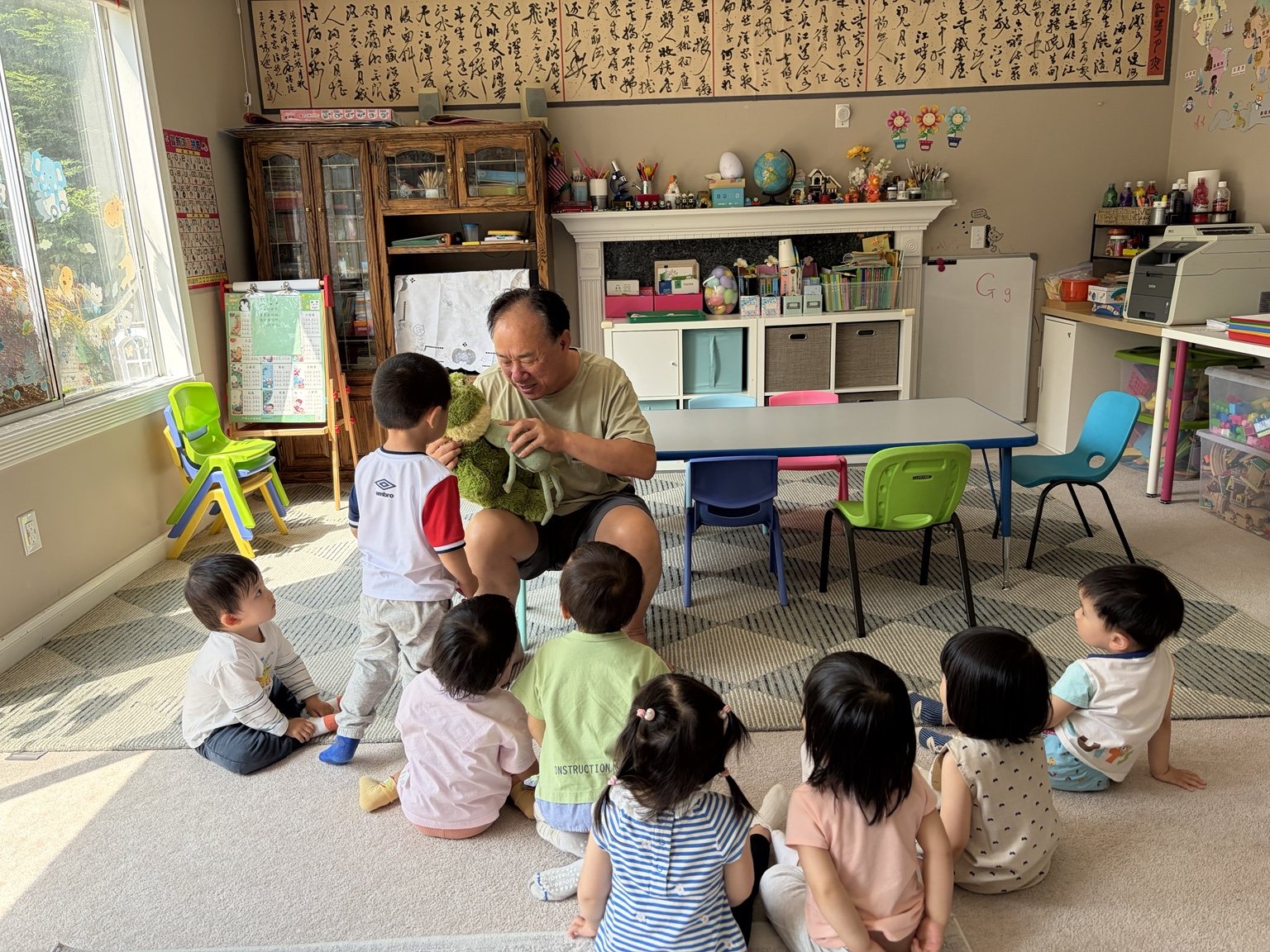 Teacher Li leading a group activity with children in the daycare classroom
